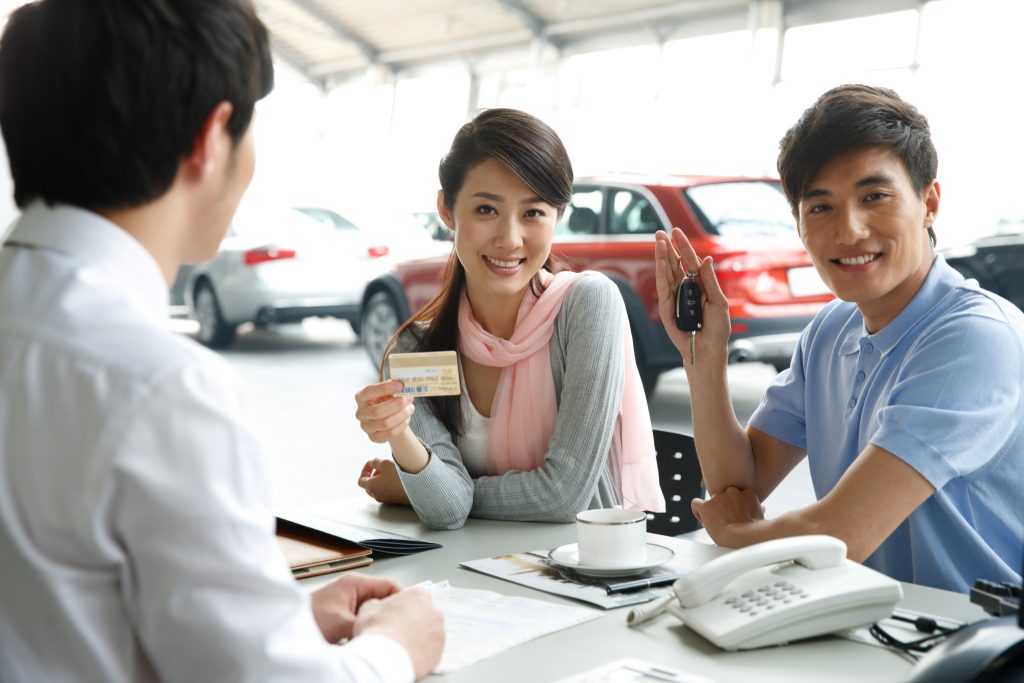 A couple buying cars in an automobile 4S shop