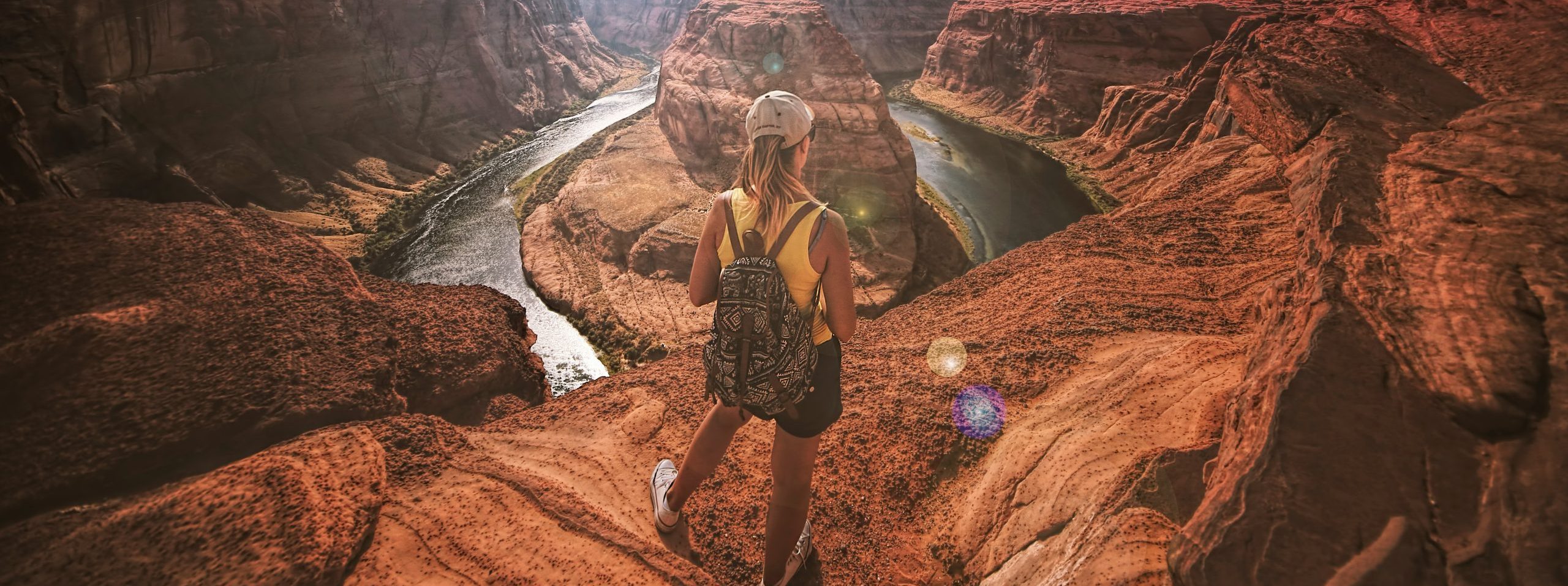 woman standing on the top of canyon